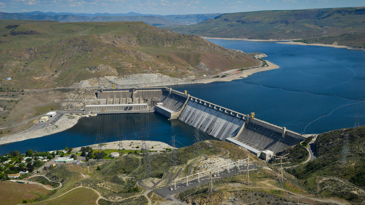 Aerials of Grand Coulee Dam. Take note of the newer materials storage building downstream of the third powerplant. A tempora